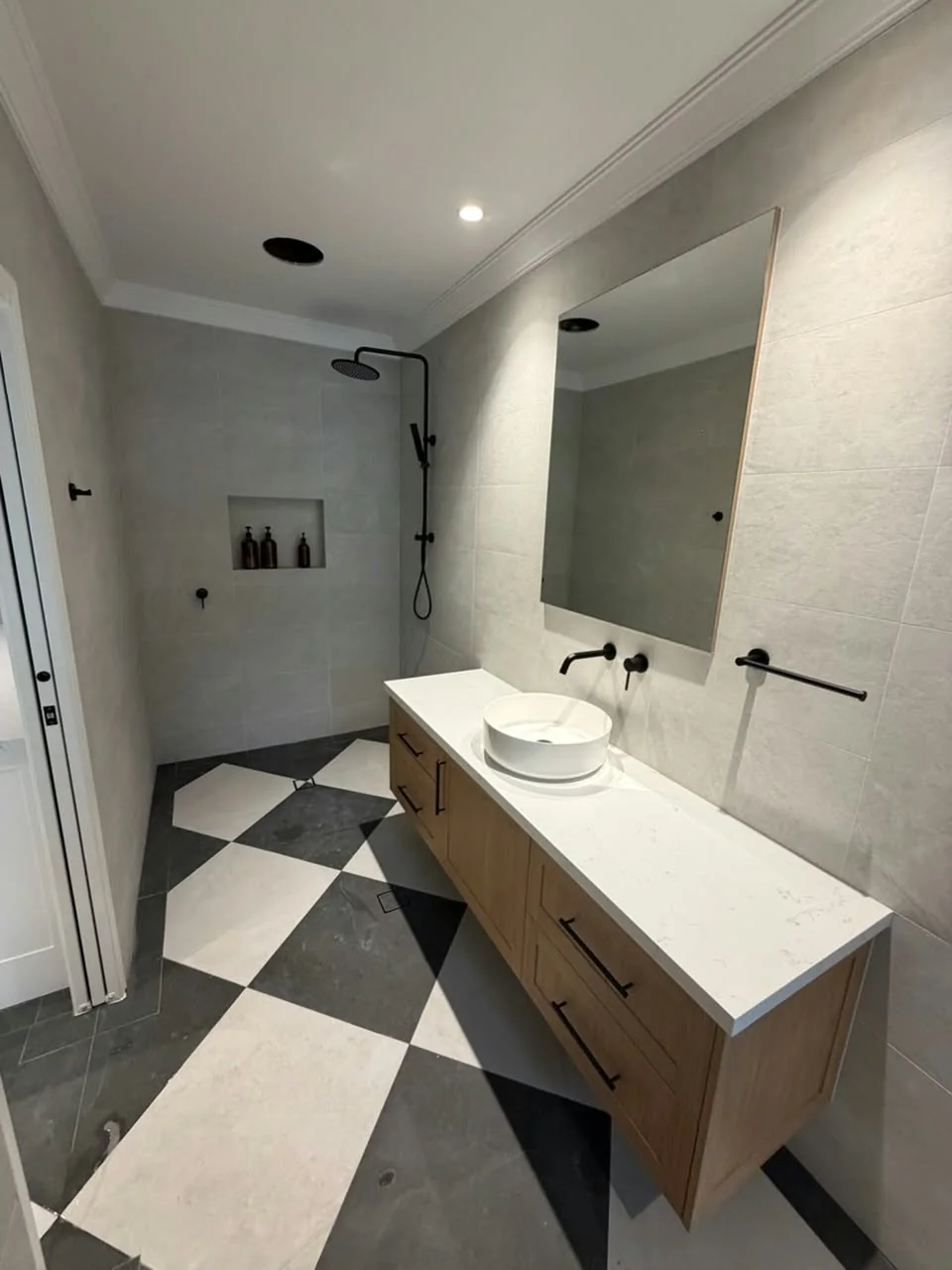 Bathroom with checkerboard floor and timber vanity